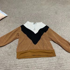 fuzzy black, tan, and white sweaqter